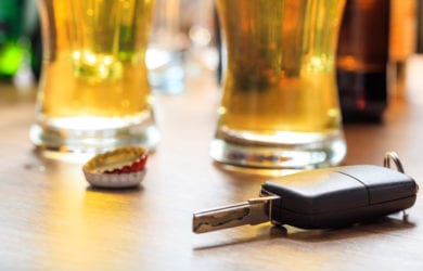 car keys with alcohol in the background