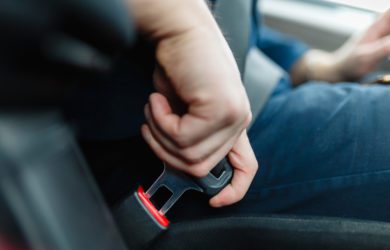 man, fastening, seat, belt, in, a, car